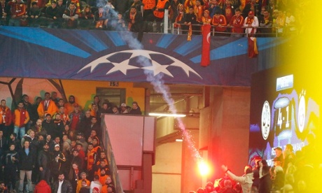 A flare is thrown during Borussia Dortmund's game against Galatasaray.