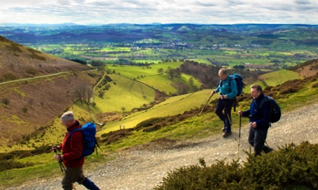 Walkers on Offa's Dyke path with a view of the market town of Ruthin