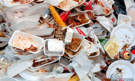 A pile of fast food wrappers, trays, and packetsdiscarded food waste