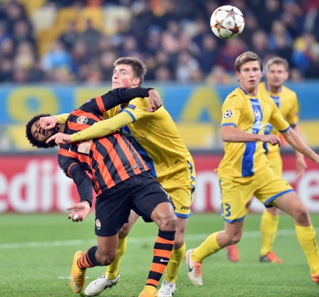 Luiz Adriano is tackled by Evgeni Yablonski 