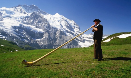 swiss horn player in the mountains