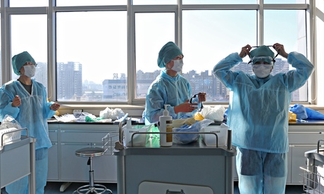Chinese medical staff receiving an Ebola training session in Beijing