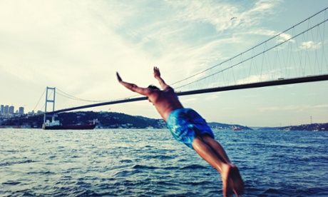A swimmer launches himself into the Bosphorous