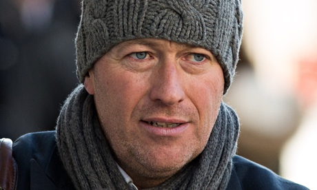 Ian Edmondson in a woolly hat and with a poppy in his lapel