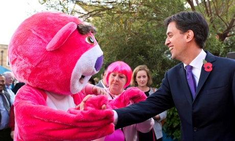 Ed Miliband shakes hands with a giant pink bear.