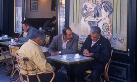 Men sit outside a café in France.