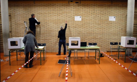 A volunteer makes preparations in a polling place, as Catalonia prepares to hold a symbolic vote on independence that is strongly opposed by the central government.