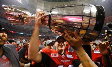 Calgary Stampeders' quarterback Bo Levi Mitchell holds the Grey Cup after the Stampeders defeated the Hamilton Tiger Cats in the CFL's 102nd Grey Cup football championship in Vancouver, British Columbia.