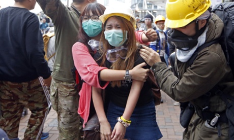 Protesters cry as they are dispersed by police officers outside government headquarters.