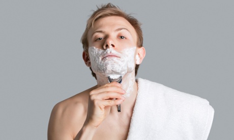 A young man, probably using a man's razor