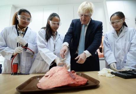 Mayor of London Boris Johnson helps to dissect a cow’s lung at Epsom College in Kuala Lumpur, Malaysia.