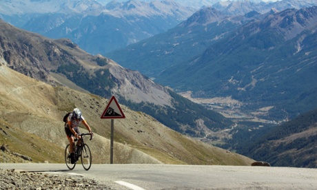 Uphill struggle? A cyclist finishing the last few metres of the climb to the Col du Galibier in the French Alps. The UK economy picked up faster than most expected in 2014 but growth is slowing down.
