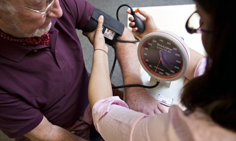 A doctor takes a patient's blood pressure
