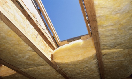 Fiberglass Insulation being installed roof in new loft style home under construction