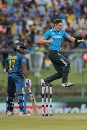 England's bowler Chris Woakes, right, celebrates the dismissal of Sri Lankan batsman Mahela Jayawardene, left, during their fifth one day international cricket match in Pallekele, Sri Lanka, Wednesday, Dec. 10, 2014. (AP Photo/Eranga Jayawardena)