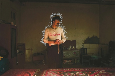 Drake: 'I took a photo of this man in his home after he and his 10 siblings sacrificed a camel to celebrate the Kurban festival. When I came back with the print, he wrote some words in Uyghur around his figure.'