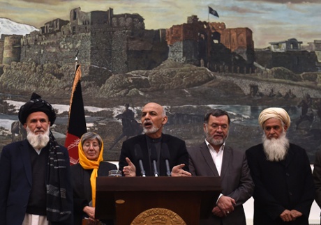 Afghan President, Ashraf Ghani (C) speaks during a press conference at the Presidential Palace in Kabul on December 10, 2014.  A