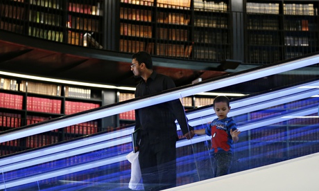 Visitors to Birmingham library after its opening in 2013. The hours are being cut from 73 to 40 with