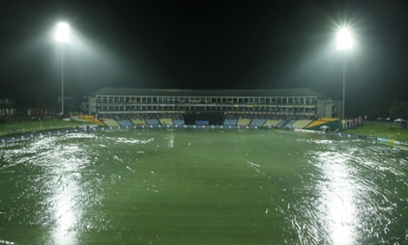 The cricket ground is seen covered in plastic sheets as rain interrupts play during the fifth one day international cricket match between Sri Lanka and England in Pallekele , Sri Lanka, Wednesday, Dec. 10, 2014. (AP Photo/Eranga Jayawardena)