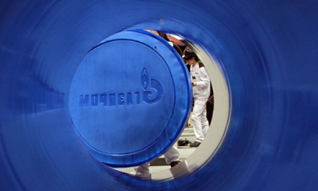 An employee attaches an OAO Gazprom labelled end cap to a steel pipe manufactured by OAO Chelpipe (ChTPZ) at the Vysota tube rolling plant in Chelyabinsk, Russia