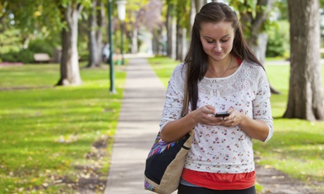 A young woman using an iPhone
