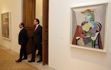 Francois Hollande (L) and Mariano Rajoy walk past the painting Portrait of Marie-Therese (1937) by Pablo Picasso at the Picasso Museum