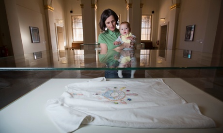 Tabitha Moses and her daughter, Gilda at the Walker Art Gallery, Liverpool. The exhibit in the case is a hospital gown embroidered with symbols of her IVF experience.