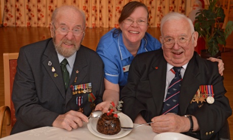Two men pictured tasting a Co-op Christmas pudding 