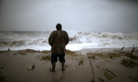 Andy Becica stands on the beach watching the heavy surf from Hurricane Sandy wash in in, on October 29, 2012 in Cape May, New Jersey. Later today the full force of Hurricane Sandy is expected to hit the New Jersey coastline bringing heavy winds and floodwaters.