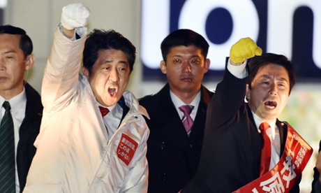 Shinzo Abe (in white coat) at a rally in Tokyo during his election campaign.