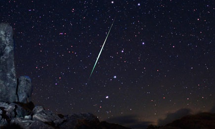 A Geminid fireball explodes over the Mojave Desert in California