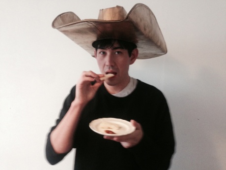 Dean Kissick eating cheese in a hat