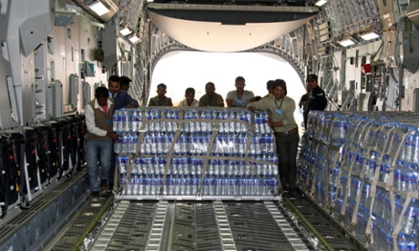 Indian workers and Air Force personnel load emergency supplies of bottled water onto a Boeing C-17 heavy transport aircraft, bound for the Maldives after a fire at a desalination plant affected water supplies.
