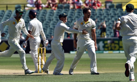 Australia's  Mitchell Johnson celebrates taking the wicket of India's Shikhar Dhawan with his team-mates.