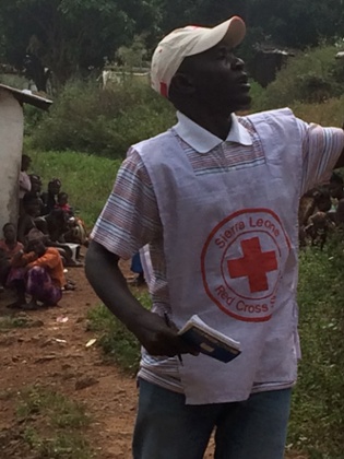 Mustapha Rogers tells neighbours of Kamara how to protect themselves from Ebola