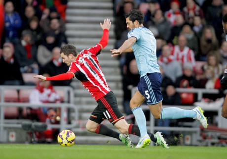 Sunderland's Adam Johnson goes down under the challenge of West Ham United's James Tomkins and the ref points to the spot.