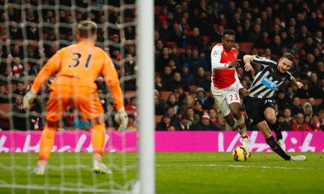 Newcastle's Paul Dummett bundles over  Danny Welbeck to concede a penalty.