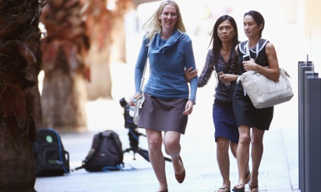 SYDNEY, AUSTRALIA - DECEMBER 15:  Girls rush through Philip Street past armed police at Lindt Cafe, Martin Place on December 15, 2014 in Sydney, Australia.  Major landmarks in Sydney, including the Sydeny Opera House, have been evacuated as police respond to a hostage situation inside a Martin Place cafe.  (Photo by Don Arnold/Getty Images)ConflictTerrorismWar