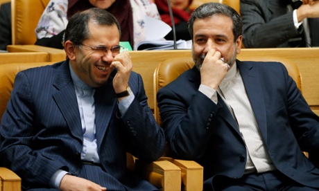 The two Iranian deputy foreign ministers Abbas Araghchi (R) and Majid Takht Ravanchi (L), who are leading the Iranian negotiating team in Geneva, share a light moment during the opening session of the international ‘Together Against Violence and Extremism’ conference in Tehran, Iran, 9 December. Araghchi later briefed a closed-door parliamentary session about the latest developments of the nuclear talks EPA/ABEDIN TAHERKENAREH