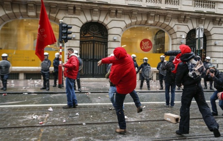 Union members throw projectiles at the VOKA headquarters in Brussels during a national general strike on December 15, 2014 in Brussels..