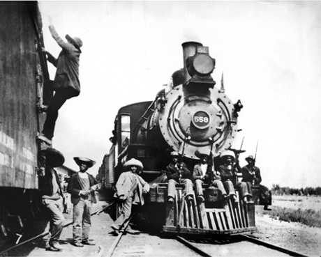Federal troops watch over trains during the Mexican civil war.