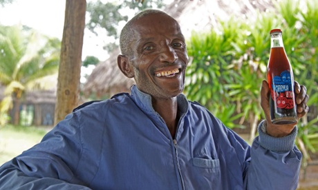 A man holding a Karma Cola and smiling