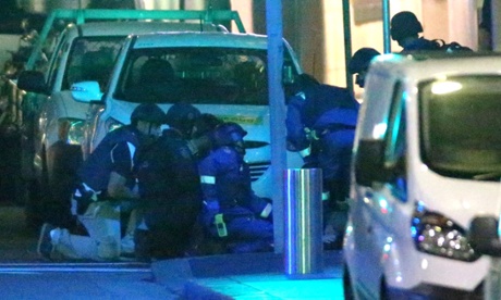 Police and paramedics administer first aid after going in to end the siege at around 2.10 am this morning in Martin Place Sydney this afternoon, Tuesday 16th December 2014. Photograph by Mike Bowers for Guardian Australiahostagecrisisaus