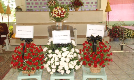 Angus McDonald's coffin with bouquets of flowers.
