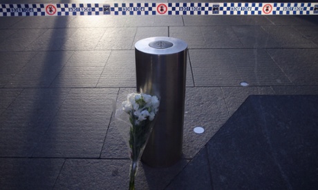 SYDNEY, AUSTRALIA - DECEMBER 16: Flowers are placed at the police cordon at Martin Place on December 16, 2014 in Sydney, Australia. 