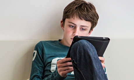 Teen boy on ereader