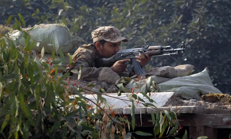 A Pakistani army soldier takes position on a bunker close to the school.