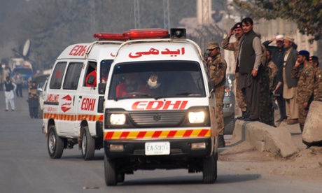 Ambulances drive away from the school