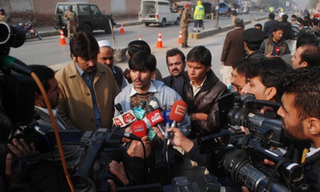 The media interview a man who was rescued from the school.