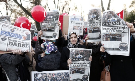 Supporters of the Hizmet movement of US-based Islamic cleric Fethullah Gulen hold copies of the Zaman newspaper as they take part in a demonstration a day after Turkish police began an operation targeting media supportive of the movement.